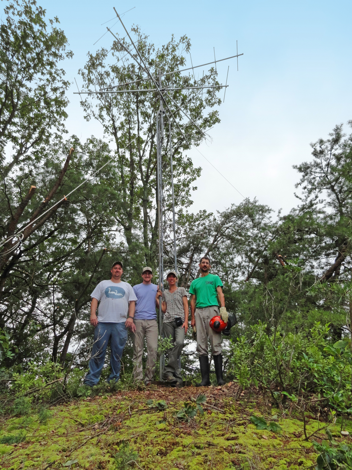 Ross Wood (Bird Studies Canada), Jon Rice (Carnegie Museum of Natural History), and Alison Fetterman (Willistown Conservation Trust) pose with landowner Jay Drasher alongside the newly erected tower installed at Neversink Mountain Preserve in Berks County.