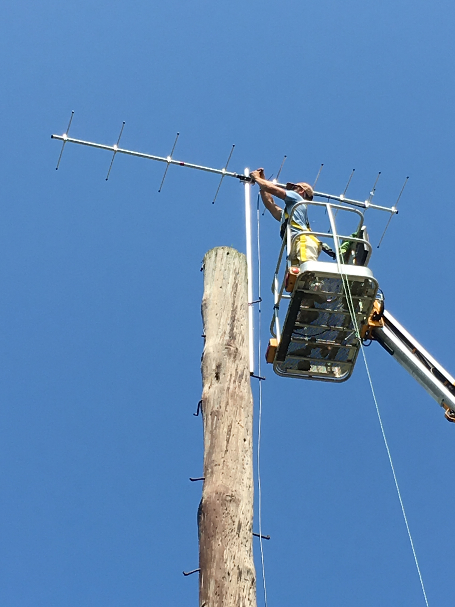 Todd Alleger works on a receiver station from a rented cherry picker in Blue Marsh and Waggoner’s Gap, PA.